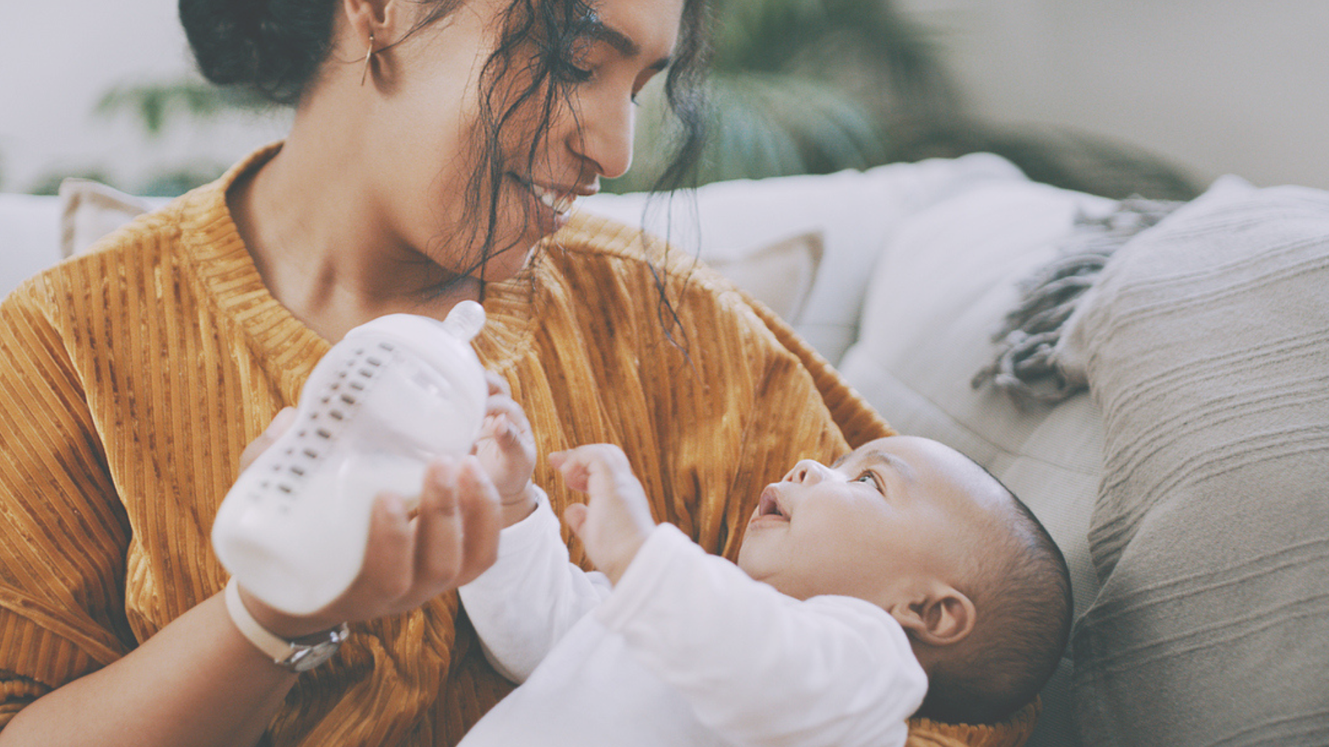 Mother bottle feeding baby