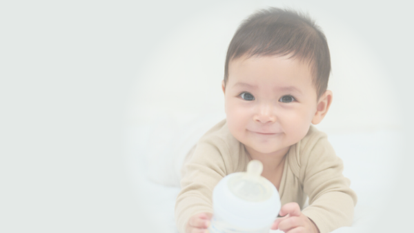 Baby holding bottle